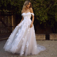 Off-the-shoulder lace wedding dress by MANDOTOS featuring appliques, A-line silhouette, and princess-style design for brides.