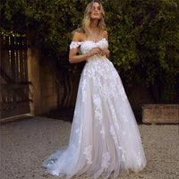 Lace off-the-shoulder wedding dress with appliques, A-line princess gown, bridal dress by MANDOTOS, detailed floral embroidery.