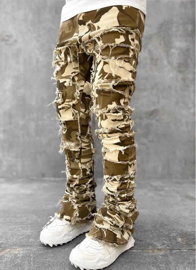 Men's stacked jeans by MANDOTOS featuring individual patches, long tight fit, and a bold style with distressed details.