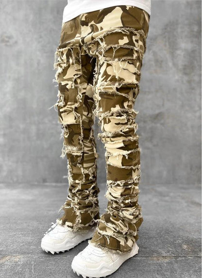 Men's stacked jeans by MANDOTOS featuring individual patches, long tight fit, and a bold style with distressed details.