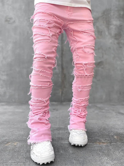 Men's stacked patched jeans by MANDOTOS, long tight-fit trousers with bold style and individual patched details.
