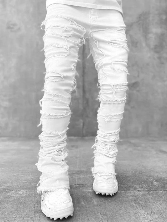Men's stacked jeans by MANDOTOS featuring patched details and a long tight fit, ideal for bold style and modern casual wear.
