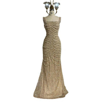 Nude elegant sling dress by MANDOTOS featuring light luxury design with pearl beaded accents and high-end style.