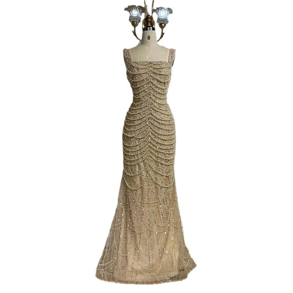 Nude elegant sling dress by MANDOTOS featuring light luxury design with pearl beaded accents and high-end style.