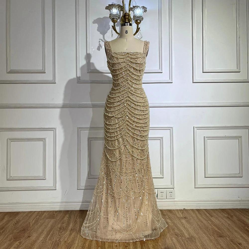 Elegant nude pearl-beaded dress by MANDOTOS featuring a sling style and luxurious high-end design.