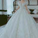 Off-shoulder French main wedding dress by MANDOTOS featuring elegant lace details and a flowing train.