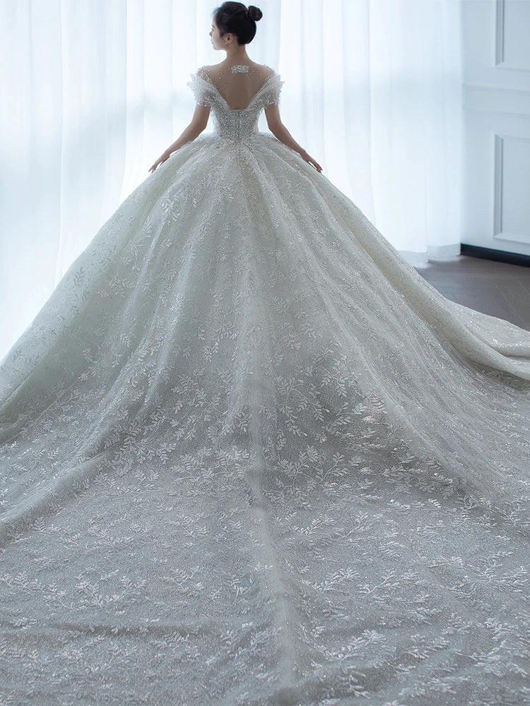 Off shoulder French main wedding dress by MANDOTOS, featuring elegant fabric and classic design perfect for bridal attire.