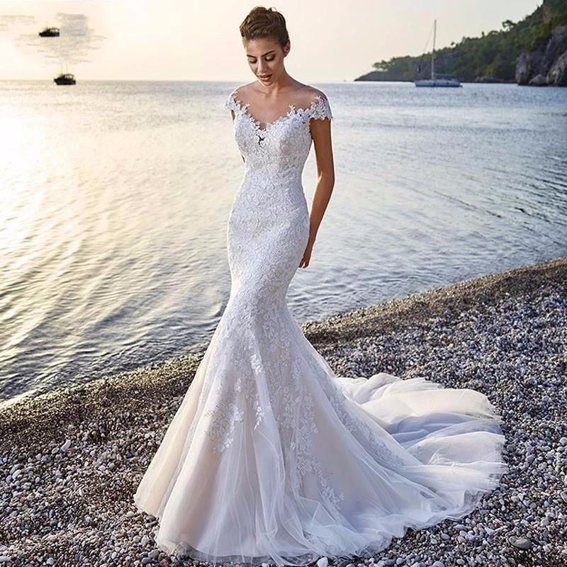 Mandotos Princess Bride Mermaid wedding dress in white with lace details, trailing backless design, elegant bridal gown.