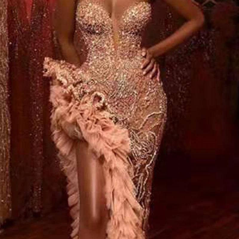 Sequin-covered black tube top dress by MANDOTOS, form-fitting with shimmering embellishments, perfect for evening wear or parties.