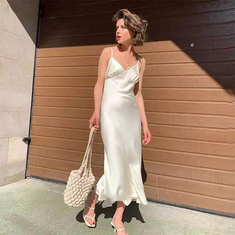 Long swing skirt with sling style and collage stitching in a sweet plain pattern, made from polyester fiber by MANDOTOS.