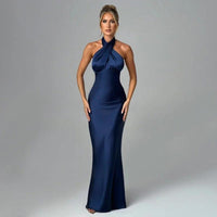 Elegant backless sleeveless summer dress by MANDOTOS, featuring a stylish design and flowing fabric for warm weather fashion.