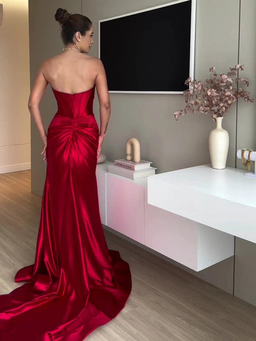 Red extra long evening dress with tube top and slit by MANDOTOS, showcasing flowing fabric and elegant design.
