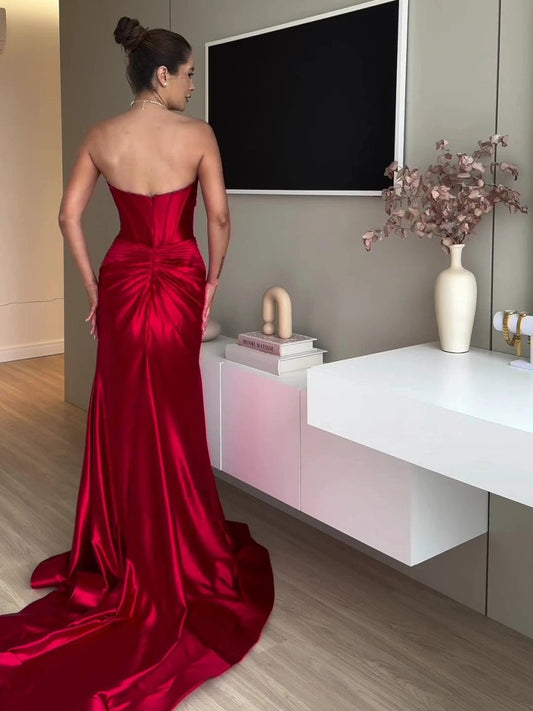 Red extra long evening dress with tube top and slit by MANDOTOS, showcasing flowing fabric and elegant design.