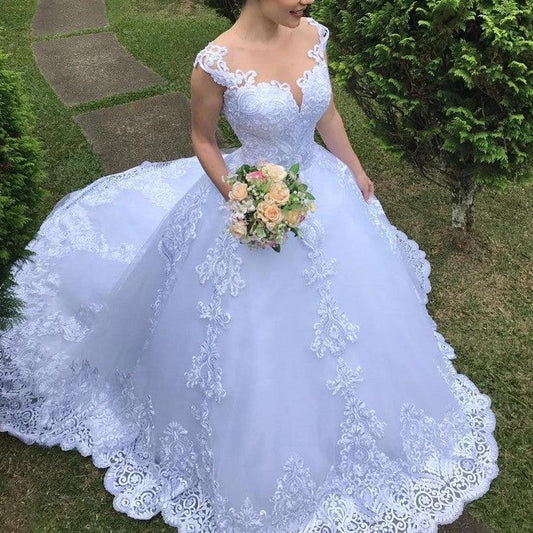 White vintage lace wedding dress by MANDOTOS featuring elegant lace details and a classic bridal gown silhouette.