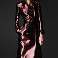 Women's slim fit leather high fashion coat by MANDOTOS, shown hanging with detailed stitching and stylish silhouette.