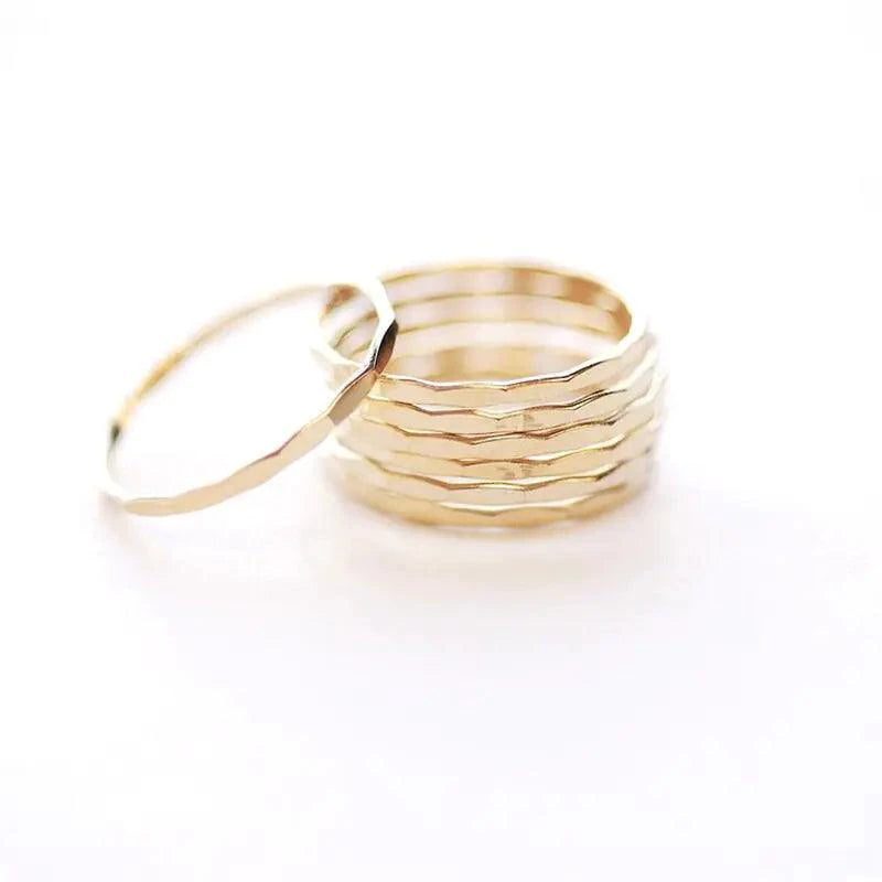 14K gold-filled textured stacking ring from MANDOTOS, showcasing a detailed hammered finish on a slim band.