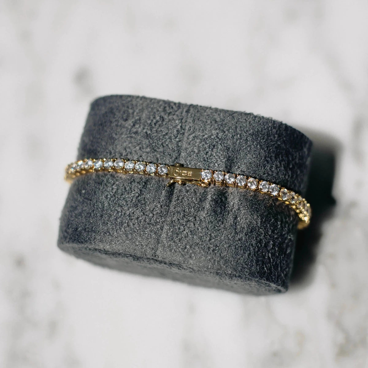 18K gold-plated zircon tennis bracelet by MANDOTOS featuring sparkling cubic zirconia stones and a sleek, elegant design.