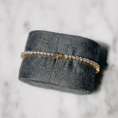 18K gold-plated zircon tennis bracelet by MANDOTOS featuring sparkling cubic zirconia stones and a sleek, elegant design.