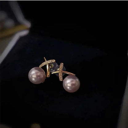 18K gold pearl stud earrings by MANDOTOS featuring elegant round white pearls and a classic, sophisticated design.