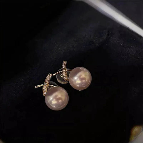 18K gold pearl stud earrings by MANDOTOS featuring elegant round pearls on classic gold posts.