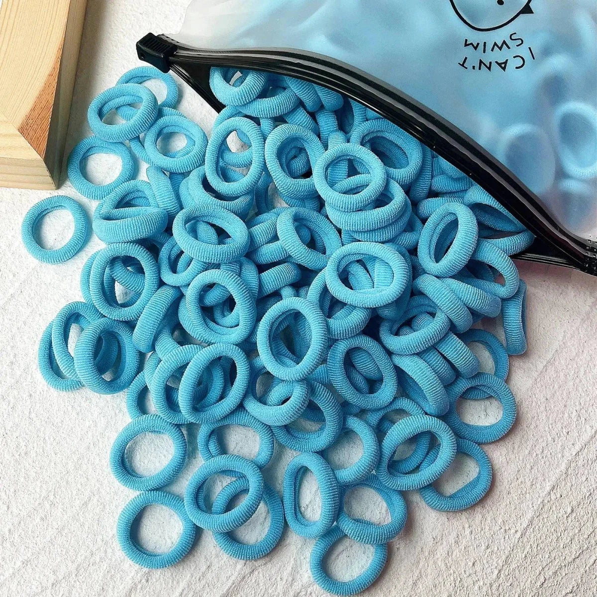 Set of 20/50 kids elastic hair bands by MANDOTOS, colorful sweets-themed scrunchies and hair ties for children and baby hair accessories.