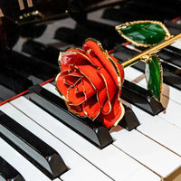 24K gold plated rose gift by MANDOTOS, featuring a beautifully crafted gold rose on a sleek display stand.