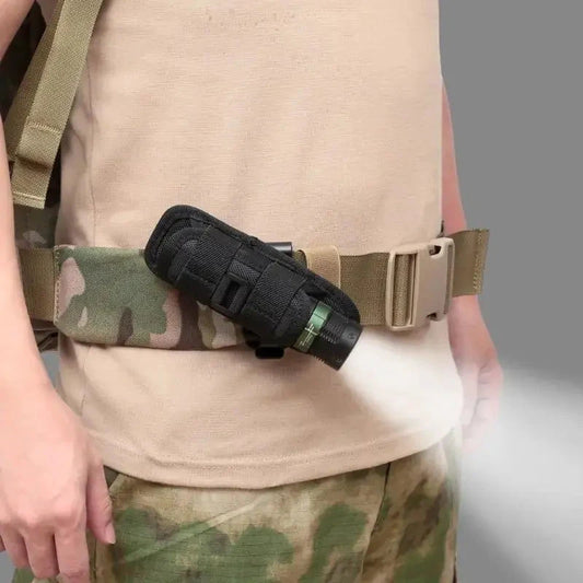 Mandotos Adventure Belt flashlight carrier attached to a hiking belt, designed for secure flashlight storage during outdoor activities.