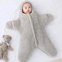 Soft baby quilt by MANDOTOS featuring colorful patterns, perfect for keeping infants warm and comfortable.