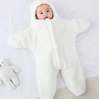 Soft baby quilt from MANDOTOS featuring colorful patterns and gentle fabric, perfect for cuddling and nursery decor.