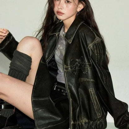 Mandotos Bow Biker's Leather Jacket featuring a stylish design, black leather, and adjustable buckle details on the collar and waist.