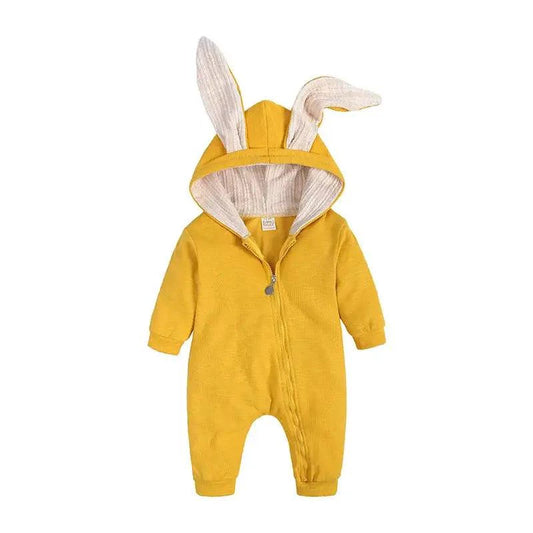 Baby wearing a cute white bunny ear onesie by MANDOTOS, featuring soft fabric and adorable bunny ear hood for cozy comfort.