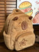 Mandotos Capybara Cuddle Backpack featuring a soft plush design and realistic capybara face for cute, cozy carrying.