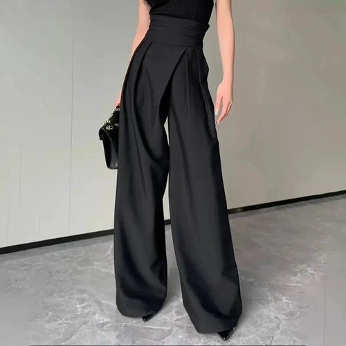 Mandotos chic flowy wide-leg trousers shown in a relaxed fit with smooth fabric and a stylish, modern silhouette.