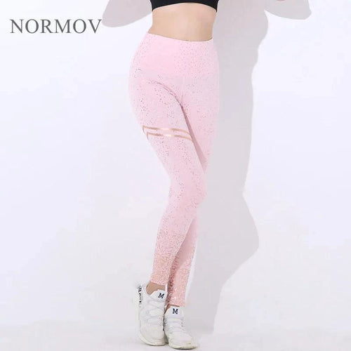 Mandotos chic gold print leggings featuring stylish gold patterns on comfortable black fabric, perfect for casual or athletic wear.