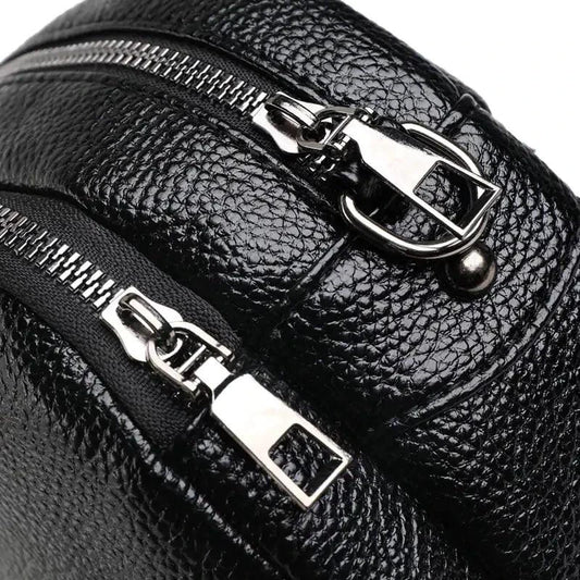 Mandotos chic leather circle purse with a sleek design, featuring a round shape and a stylish finish.