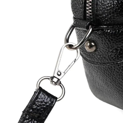 Mandotos chic leather circle purse with a sleek design and top handle, perfect for stylish accessories.
