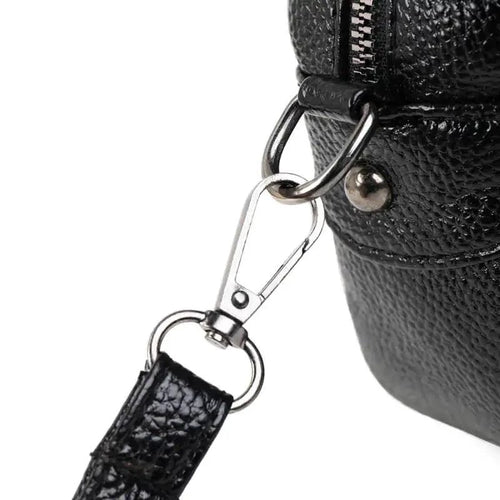 Mandotos chic leather circle purse with a sleek design and top handle, perfect for stylish accessories.