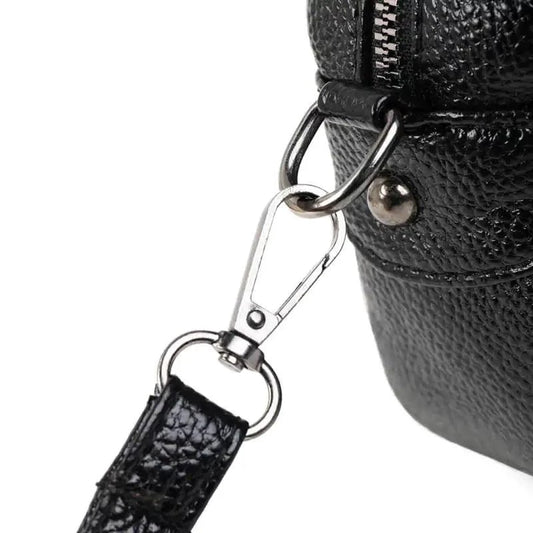 Mandotos chic leather circle purse with a sleek design and top handle, perfect for stylish accessories.