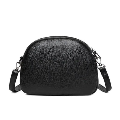 Mandotos chic leather circle purse with a sleek design and zipper closure, perfect for stylish everyday use.