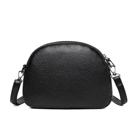 Mandotos chic leather circle purse with a sleek design and zipper closure, perfect for stylish everyday use.