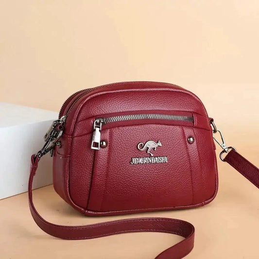 Mandotos chic leather circle purse with adjustable strap and gold-tone hardware, stylish accessory for everyday use.