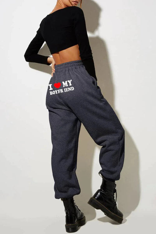 Mandotos chic love print trousers featuring a stylish pattern and tailored fit, perfect for casual or semi-formal wear.