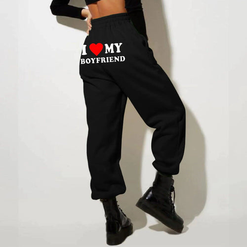 Mandotos Chic Love Print Trousers featuring a stylish heart pattern, slim fit, and comfortable fabric for casual or trendy wear.