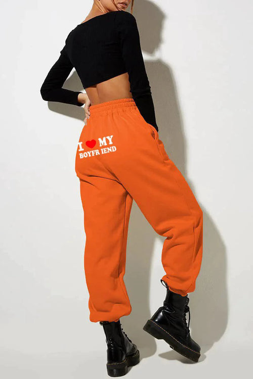 Mandotos Chic Love Print Trousers featuring stylish love-themed pattern and tailored fit, perfect for casual or fashionable wear.