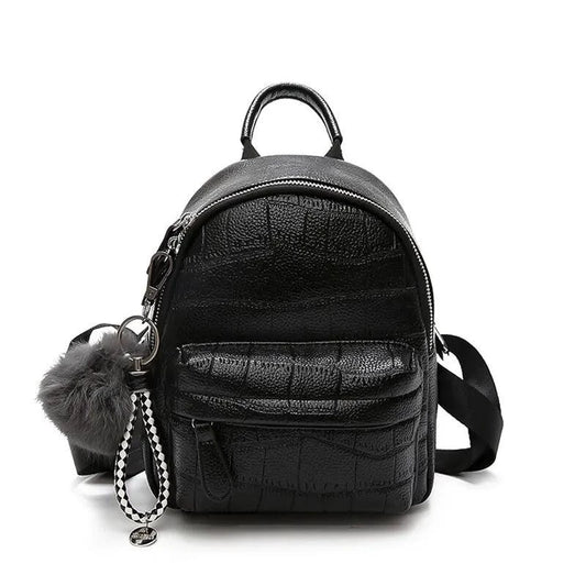 Mandotos chic mini leather backpack with top handle and adjustable straps, featuring a sleek design and compact size.