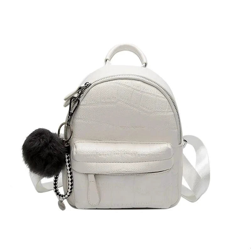 Mandotos chic mini leather backpack with adjustable straps and top handle, featuring sleek design and compact size.