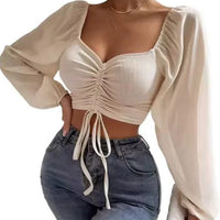Mandotos chic v-neck balloon sleeve crop top shown on a model, featuring stylish design and lightweight fabric.