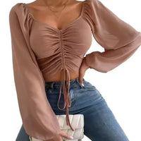 Mandotos chic v-neck crop top with balloon sleeves, stylish and trendy, shown in a close-up image highlighting the design details.