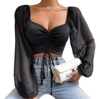 Mandotos chic V-neck balloon sleeve crop top displayed on a hanger, showcasing stylish design and vibrant fabric.