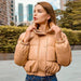 Mandotos chic winter PU leather jacket displayed on a hanger, featuring a stylish design and smooth black leather texture.